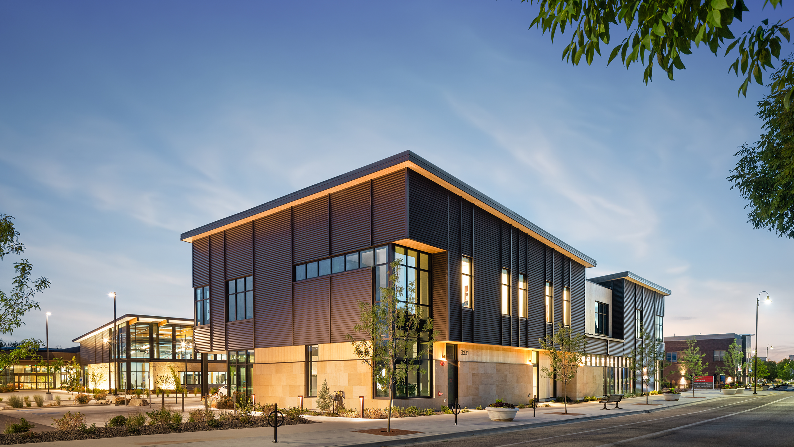 An evening photograph featuring the Summit building with The Idaho Outdoor Fieldhouse in the background